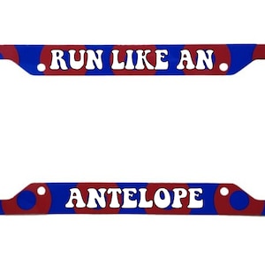 May include: Red and blue license plate frame with white text that reads "RUN LIKE AN ANTELOPE".