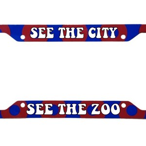 May include: Red and blue license plate frame with white text that says "See the City" and "See the Zoo".