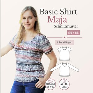 May include: A woman wearing a patterned short-sleeve shirt and blue jeans. The image includes the text "Basic Shirt Maja Schnittmuster EN + DE" and size information for EU 34-50 and US 4-20. Also shown are shirt diagrams and the text "4 Ärmellängen" and "A4-A0-Letter".
