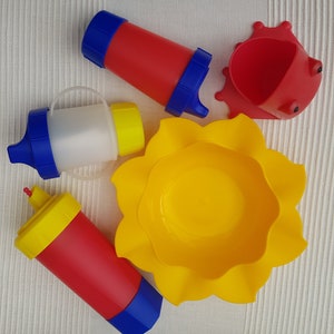 Baby tableware set, Made in Germany. Set consists of 1 cup, 1 cup with handle, 1 fizzy cup (for ages 2 and up), 1 sun plate, 1 feeding frog.