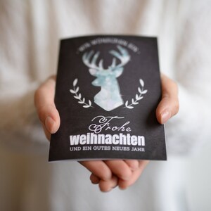Frohe Weihnachten - Karte mit einem funkelnden Hirsch und einem kleinem Spruch