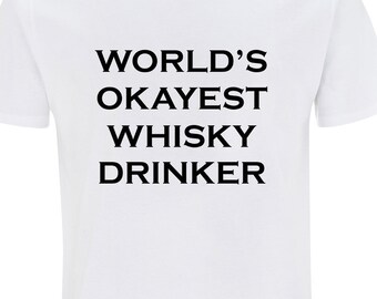 May include: White t-shirt with black text that reads "WORLD'S OKAYEST WHISKY DRINKER"