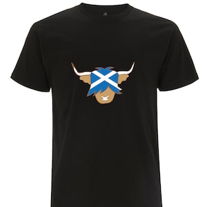 May include: Black t-shirt with a brown Highland cow wearing a Scottish flag on its head.