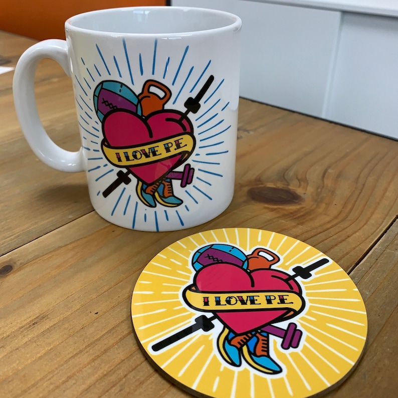 May include: White ceramic mug with a colorful illustration of a heart with the text "I LOVE PE" and various sports equipment. The mug is paired with a matching yellow coaster.