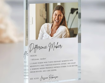 May include: A clear acrylic block featuring a photograph of a smiling person in a white shirt. Below the photo, the text reads: Difference Maker (NOUN) /'dif(ə)rəns 'meɪkər/ 1. A RARE HUMAN WHO TURNS ORDINARY MOMENTS INTO MEANINGFUL ONES.