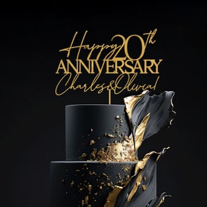 May include: Gold cake topper with the text "Happy 20th Anniversary Charles & Olivia!" on a black and gold cake.