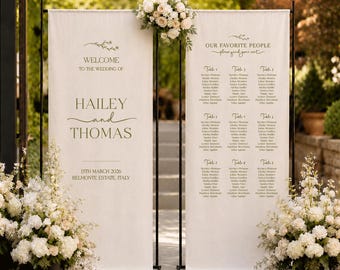 May include: Two vertical off-white fabric banners suspended on black metal stands. The left banner reads WELCOME TO THE WEDDING OF HAILEY and THOMAS 13TH MARCH 2026 BELMONTE ESTATE, ITALY. The right banner lists OUR FAVORITE PEOPLE with table assignments.