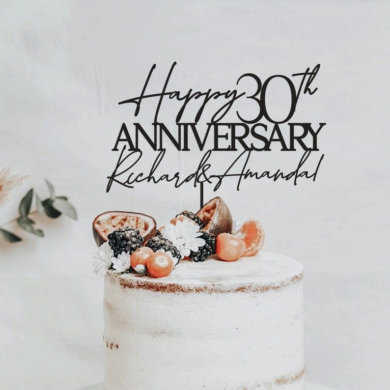 May include: Black acrylic cake topper with the text "Happy 30th Anniversary Richard & Amanda".