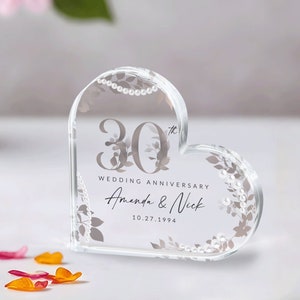 May include: A clear heart-shaped crystal paperweight with a floral design and the text "30th Wedding Anniversary Amanda & Nick 10.27.1994"