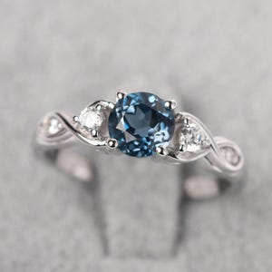 Delicate London blue topaz infinity engagement ring sterling silver round cut twist ring November birthstone