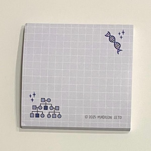 May include: A square notepad with a light grey grid pattern. The notepad features a DNA helix and a family tree diagram in blue. The text "© 2025 Madison Seto" is printed at the bottom right corner.