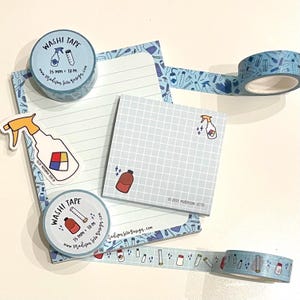 May include: A collection of stationery items with a science theme. Includes washi tape rolls, lined and grid notepads, and stickers. The washi tape is 15 mm wide and 10 m long, featuring lab equipment and cleaning spray bottle designs.