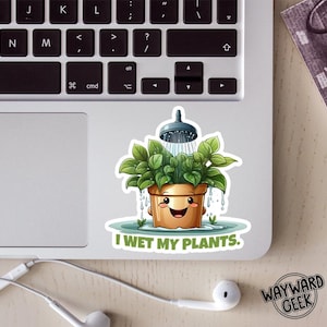May include: A sticker featuring a cartoon plant in a pot being showered. The plant has green leaves and a smiling face. The text "I WET MY PLANTS" is below the plant. The sticker is on a laptop.