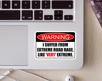 May include: A white warning sticker with black and red text that reads "WARNING I SUFFER FROM EXTREME ROAD RAGE. LIKE 'VERY' EXTREME."