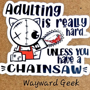 May include: A white sticker with a cartoon illustration of a stitched-up monster holding a bloody chainsaw. The text reads "Adulting is really hard... unless you have a chainsaw" and "Wayward Geek" at the bottom.