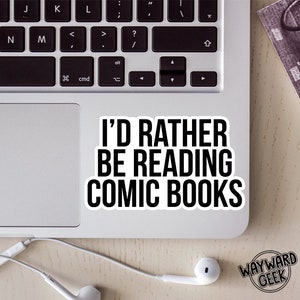 May include: A white laptop with a black sticker that reads "I'd rather be reading comic books".