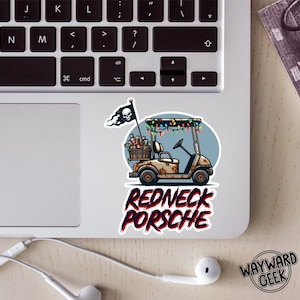 May include: A sticker featuring a golf cart with a wooden crate of beverages, a skull flag, and colorful string lights. The text REDNECK PORSCHE is printed in a distressed red font below the golf cart illustration on a light blue circular background.