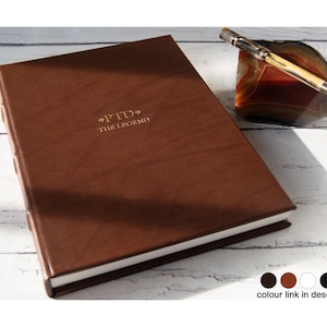 May include: A brown leather-bound journal with gold lettering that reads "PTD* THE LEGEND".