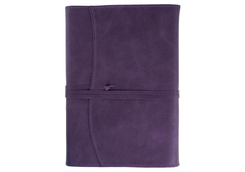 May include: A purple leather journal with a tied closure. The journal has a textured surface and a simple design.
