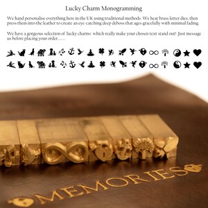 May include: A set of brass letter dies with various lucky charm designs, including an infinity symbol, a heart, an anchor, a tree, and a leaf. The dies are arranged on a brown leather surface with the word "MEMORIES" embossed in gold.