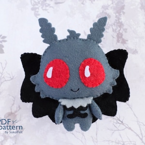 May include: A handmade felt moth plushie with a gray body, large red eyes, and black wings. The plushie has a white collar and a small, smiling face. The text "PDF pattern by SokolFelt" is visible in the lower left corner.