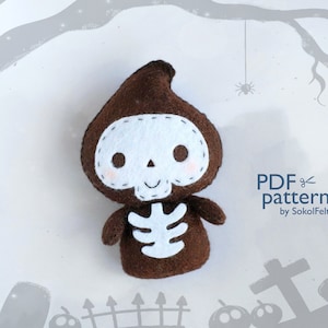 May include: A brown felt skeleton with a white skull and ribcage, wearing a brown hooded robe. The image is set against a white background with a grey tree branch and a spider hanging from it. The text "PDF pattern by SokolFelt" is in the bottom right corner.