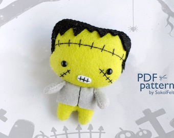 May include: A felt Frankenstein monster toy with green skin, black hair, and stitched details. The toy is wearing a gray shirt and has a friendly expression. The image includes the text "PDF pattern by SokolFelt".