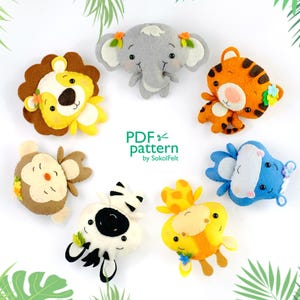 May include: A collection of handmade felt animal ornaments, including a lion, elephant, tiger, monkey, zebra, giraffe, and a blue hippo. Each animal has a unique design with floral accents. The text "PDF pattern by SokolFelt" is also visible.