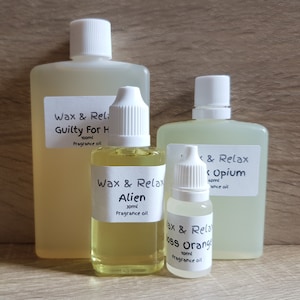 May include: Three glass bottles of fragrance oil with white caps. The bottles are labelled "Wax & Relax Guilty For Him 100ml Fragrance oil", "Wax & Relax Alien 30ml Fragrance oil", and "Wax & Relax Black Opium 60ml Fragrance oil".