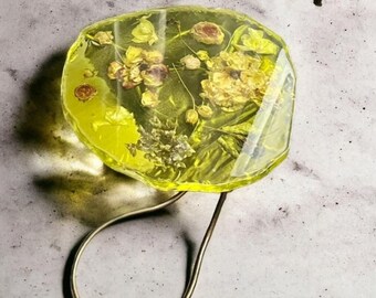 Resin coffee table with embedded flowers and metal leg