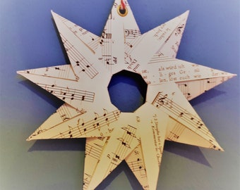 medium stars made of music paper, hand-folded, nine points, loop for hanging, Christmas