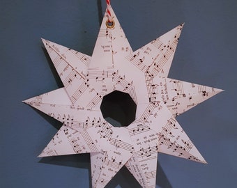 large stars made of music paper, hand-folded, nine points, loop for hanging, Christmas