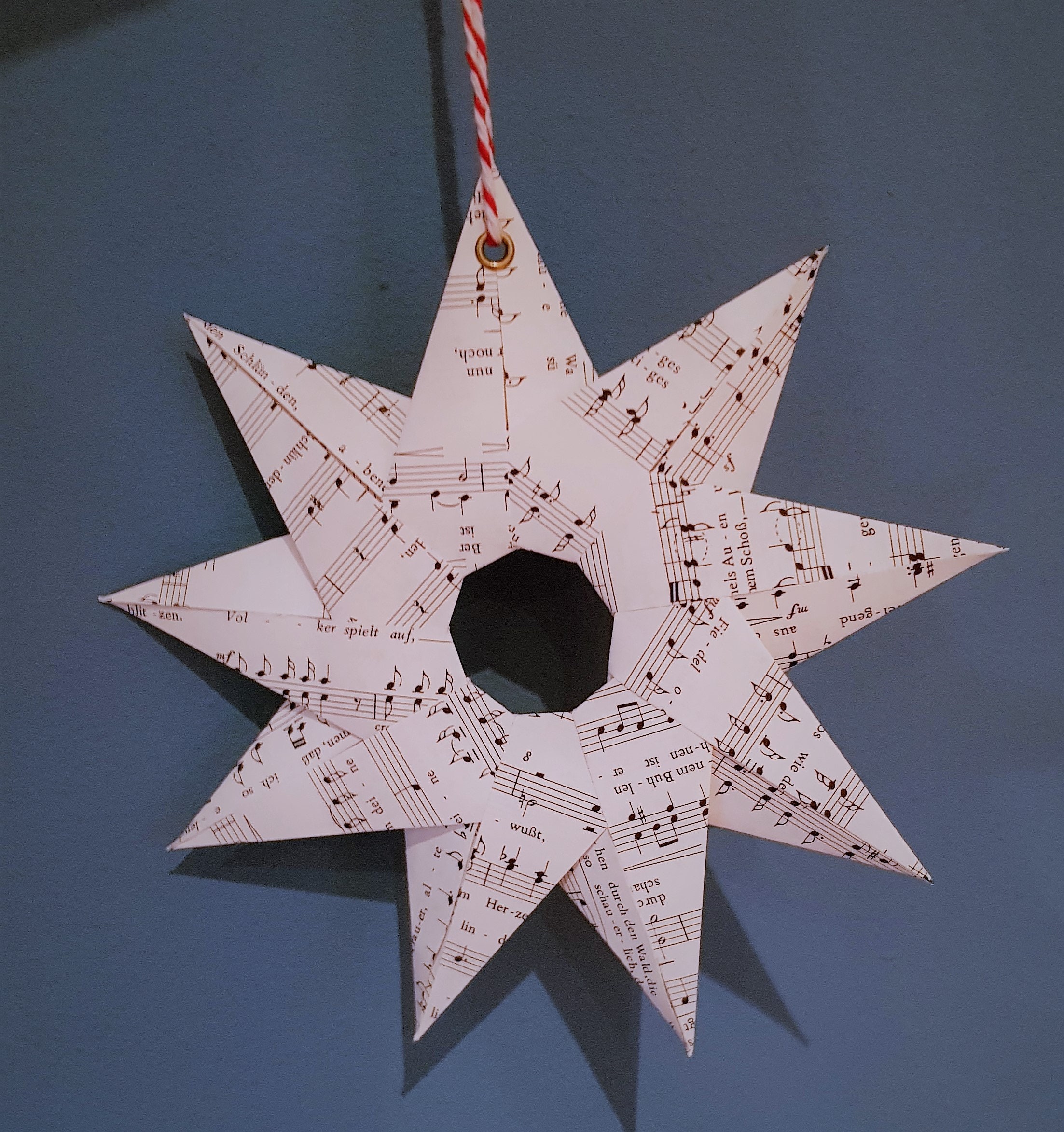 large stars made of music paper, hand-folded, nine points, eyelet for hanging, Christmas