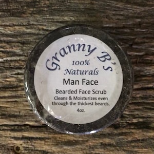 May include: A black jar with a white label that reads "Granny B's 100% Naturals Man Face Bearded Face Scrub Cleans & Moisturizes even through the thickest beards. 4oz."