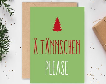 May include: A green Christmas card with a red Christmas tree and the text "A TÄNNSCHE PLEASE" in white.
