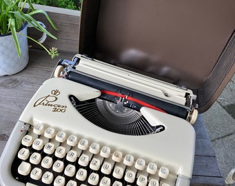 Vintage Princess 100 typewriter in a brown case from the 1960s