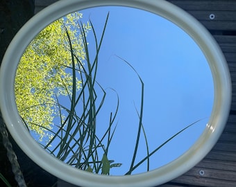 Vintage oval wall mirror made of plastic, 1970s. Oval mirror from the 1970s, beige, retro vintage.