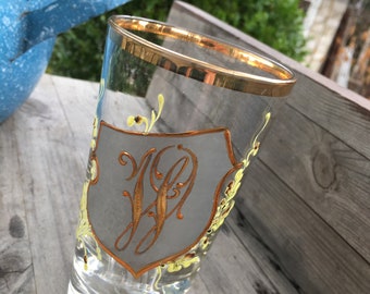a very nice old drinking glass decorated with a coat of arms and the initials- J&P