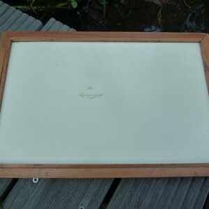 May include: A wooden tray with a white surface and a handwritten inscription that reads "N.B.I.  C. Zimmermann".