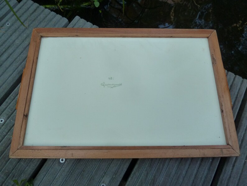 May include: A wooden tray with a white surface and a handwritten inscription that reads "N.B.I.  C. Zimmermann".