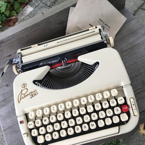 Vintage typewriter Princess 300 in brown suitcase from the 60s