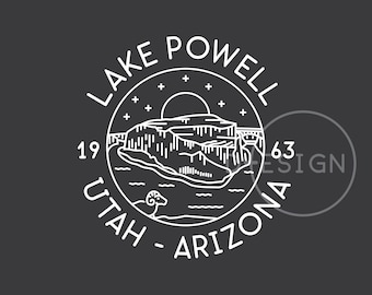 May include: A black and white line art illustration of a mountain range with a sun and stars in the sky. The text "LAKE POWELL UTAH - ARIZONA" is written in a circle around the mountain range.
