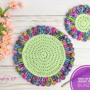 May include: Two crocheted coasters with a green center and a colorful, textured border. The coasters are on a white wooden surface. The text "BOBBLE NO WOBBLE CROCHET PATTERN BUNDLE" is in a purple circle.
