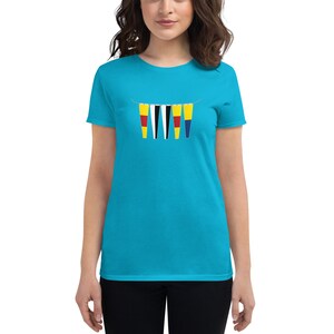 May include: A turquoise blue women's t-shirt featuring a graphic of a string of five colourful pennants. The pennants are yellow, black, white, red and blue.