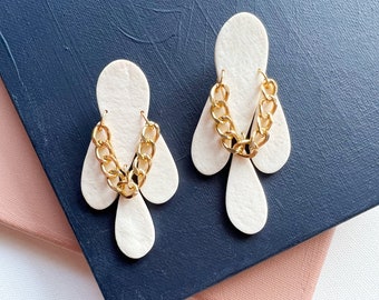 Off-white statement earrings with teardrop pendants and gold chain accent