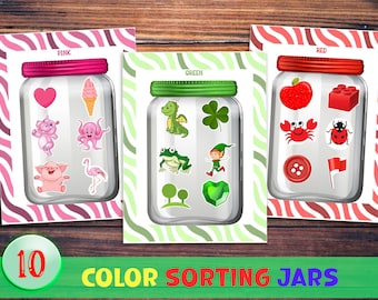May include: Set of three color sorting jars with images of various objects. The jars are labeled "Pink", "Green", and "Red". Each jar has a clear glass body and a lid with the corresponding color. The images include a heart, a hippopotamus, an octopus, an ice cream cone, a dragon, a four-leaf clover, a frog, a gnome, a tree, a gem, an apple, a red block, a crab, a ladybug, a button, and a flag.