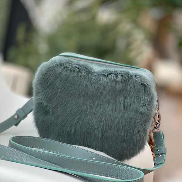 Camera-bag style in aqua-hued leather and a touch of fur