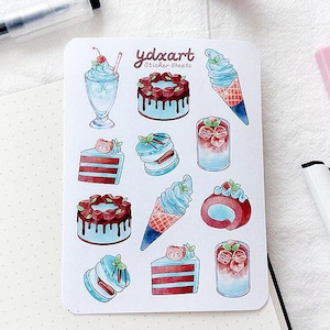 May include: A sheet of stickers featuring various blue and red desserts, including cakes, ice cream cones, and pastries. The stickers are printed with the text "ydozart sticker sheets".