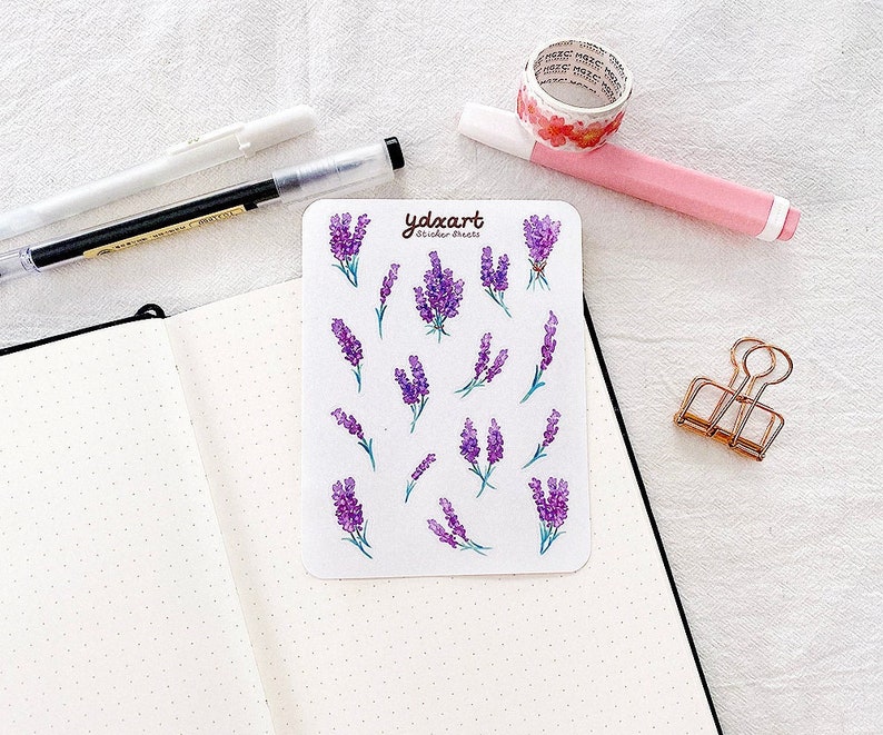May include: A sheet of lavender flower stickers with the text "ydxart sticker sheets" printed on the top. The stickers are on a white background.