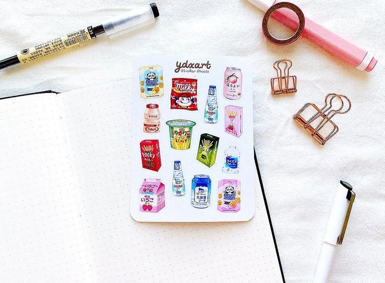 May include: A sheet of colorful stickers featuring various Japanese snacks and drinks. The stickers include a can of milk, a box of Pocky, a can of peach juice, and a bottle of water. The stickers are perfect for adding a touch of Japanese culture to your planner, journal, or laptop.